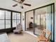 Screened porch with access to the living room, featuring a ceiling fan at 12914 Fairway Dr # A, Hudson, FL 34667