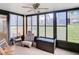 Spacious screened porch with seating, ceiling fan, and views of the community at 12914 Fairway Dr # A, Hudson, FL 34667