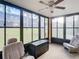 Inviting screened porch with seating and a ceiling fan at 12914 Fairway Dr # A, Hudson, FL 34667