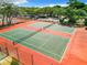 Two tennis courts with green and orange surface at 12914 Fairway Dr # A, Hudson, FL 34667