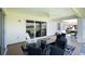 Relaxing covered back patio with seating area overlooking the backyard at 13346 Carter Ave, Port Charlotte, FL 33981
