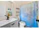 Clean bathroom with white sink, gray vanity, and starfish-themed shower curtain at 13346 Carter Ave, Port Charlotte, FL 33981