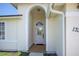 Elegant arched entryway leading to the front door of this inviting home at 13346 Carter Ave, Port Charlotte, FL 33981