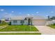 Charming single-story home with a welcoming front yard and attached garage at 13346 Carter Ave, Port Charlotte, FL 33981