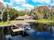 Beautiful lakefront home featuring a private dock and lush green surroundings at 18120 Wayne Rd, Odessa, FL 33556