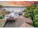 Scenic view of a lakefront home featuring a dock and serene water views at 18120 Wayne Rd, Odessa, FL 33556