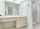 Well-lit bathroom with large mirror, shower, and tile flooring at 18120 Wayne Rd, Odessa, FL 33556