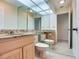 Bright bathroom with granite countertops and mirrored walls at 18120 Wayne Rd, Odessa, FL 33556