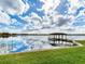 Serene lakefront view with a private covered dock at 18120 Wayne Rd, Odessa, FL 33556