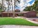 Brick home with a landscaped lawn and walkway at 18120 Wayne Rd, Odessa, FL 33556