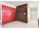 Entryway featuring vibrant red doors, a brick accent wall, and tile flooring at 18120 Wayne Rd, Odessa, FL 33556