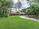 Brick home with a circular driveway, a large front yard, and mature trees at 18120 Wayne Rd, Odessa, FL 33556
