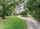 Wide driveway to a home with mature trees and expansive lawn at 18120 Wayne Rd, Odessa, FL 33556