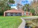 Back view of a ranch home showcasing a screened porch at 18120 Wayne Rd, Odessa, FL 33556