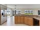 Lake view from kitchen with stainless steel fridge, and granite countertops at 18120 Wayne Rd, Odessa, FL 33556