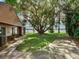 Side yard with lake view and large oak tree at 18120 Wayne Rd, Odessa, FL 33556