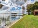 Expansive grassy yard leading to a lakefront dock at 18120 Wayne Rd, Odessa, FL 33556