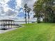 Landscaped yard with lush grass and lake access at 18120 Wayne Rd, Odessa, FL 33556