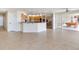 Spacious living room with tile floors, island, granite counters and stainless steel appliances at 18120 Wayne Rd, Odessa, FL 33556