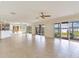 Spacious living room with multiple sliding glass doors and lake views at 18120 Wayne Rd, Odessa, FL 33556
