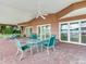 Screened porch with lake view and dining furniture at 18120 Wayne Rd, Odessa, FL 33556