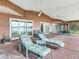 Relaxing screened porch with lake view, brick flooring, and patio furniture at 18120 Wayne Rd, Odessa, FL 33556