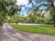 Private tennis court with green surroundings at 18120 Wayne Rd, Odessa, FL 33556