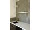 Close up of bar area with herringbone tile backsplash, quartz countertop, and modern pendant lighting at 1910 N Tampania Ave, Tampa, FL 33607