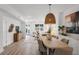 Open concept dining area with stylish light fixture that seamlessly connects to the living space at 1910 N Tampania Ave, Tampa, FL 33607