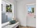 Bright entryway with window seating featuring stylish pillows next to glass door at 1910 N Tampania Ave, Tampa, FL 33607