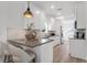 Modern kitchen with white cabinets, a breakfast bar, and sleek countertops; a chef's dream at 1910 N Tampania Ave, Tampa, FL 33607