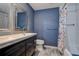 Stylish bathroom with blue wall accent, modern vanity, and combined tub and shower at 2993 W Vina Del Mar Blvd, St Pete Beach, FL 33706
