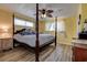 Comfortable bedroom features wood-look flooring, neutral paint, and a canopy bed at 2993 W Vina Del Mar Blvd, St Pete Beach, FL 33706