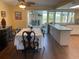 Bright dining area featuring wood floors, stylish furniture, and seamless access to the lanai at 2993 W Vina Del Mar Blvd, St Pete Beach, FL 33706