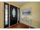 Inviting foyer features beautiful hardwood floors, an elegant entry door, and stylish decor at 2993 W Vina Del Mar Blvd, St Pete Beach, FL 33706
