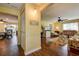 Welcoming living room featuring hardwood floors with view to dining room, kitchen and backyard at 2993 W Vina Del Mar Blvd, St Pete Beach, FL 33706