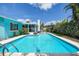 The sparkling pool invites you for a swim, with the house and lush greenery creating a private oasis at 2993 W Vina Del Mar Blvd, St Pete Beach, FL 33706