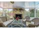 Inviting sunroom with wicker furniture, fireplace, and views of the garden at 2993 W Vina Del Mar Blvd, St Pete Beach, FL 33706