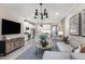 Open concept living room and kitchen with modern decor and access to a balcony at 3218 Moonlit Lily Pl, Brandon, FL 33511