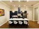 Modern kitchen featuring navy blue cabinets, white countertops, gold accents, and an island with seating at 3713 Old Mulberry Rd, Plant City, FL 33567