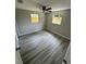 Spacious bedroom with wood-look flooring and ample natural light at 5038 Galaxy Dr, New Port Richey, FL 34652