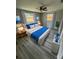 Stylized bedroom featuring a queen bed with new ceiling fan and dual windows at 5038 Galaxy Dr, New Port Richey, FL 34652