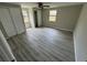 Bedroom featuring wood-look floors, ceiling fan, and closet space at 5038 Galaxy Dr, New Port Richey, FL 34652