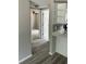 Hallway with wood-look flooring leading to various rooms at 5038 Galaxy Dr, New Port Richey, FL 34652