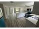 Modern kitchen with white cabinets, teal appliances, and an island with seating at 5038 Galaxy Dr, New Port Richey, FL 34652