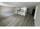 Open-concept living area with wood-look flooring, showcasing the kitchen and dining space at 5038 Galaxy Dr, New Port Richey, FL 34652