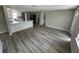 Open floor plan living room and kitchen with wood-look flooring at 5038 Galaxy Dr, New Port Richey, FL 34652