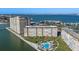 Aerial view of a residential complex with a pool near a body of water at 5130 Brittany S Dr # 505, St Petersburg, FL 33715