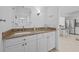 Half bath with granite countertop, white cabinetry, and view of the kitchen at 5130 Brittany S Dr # 505, St Petersburg, FL 33715