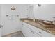 Guest bathroom featuring granite countertop and white cabinetry at 5130 Brittany S Dr # 505, St Petersburg, FL 33715